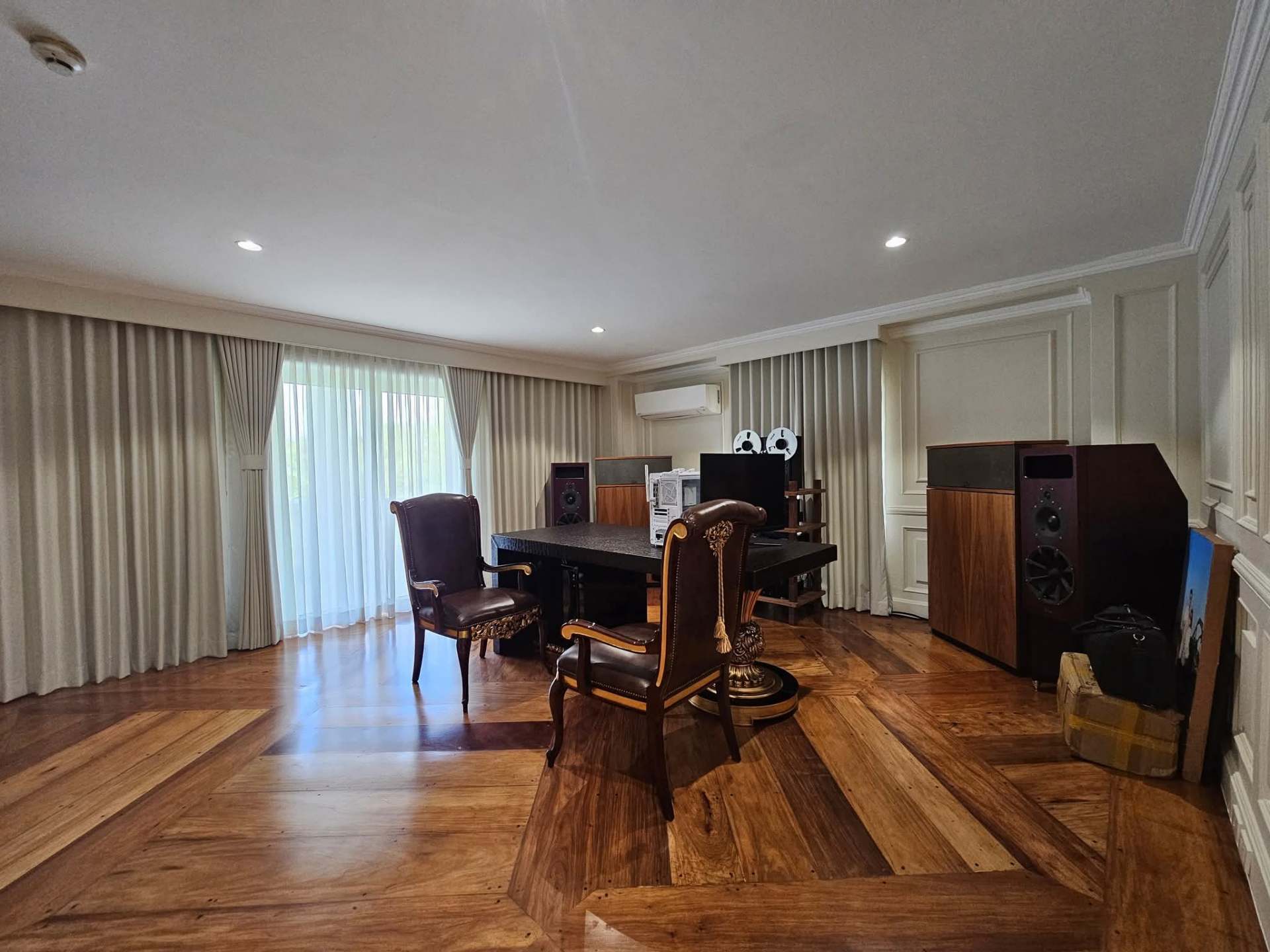Ground-floor office with herringbone wood floors and audio listening setup