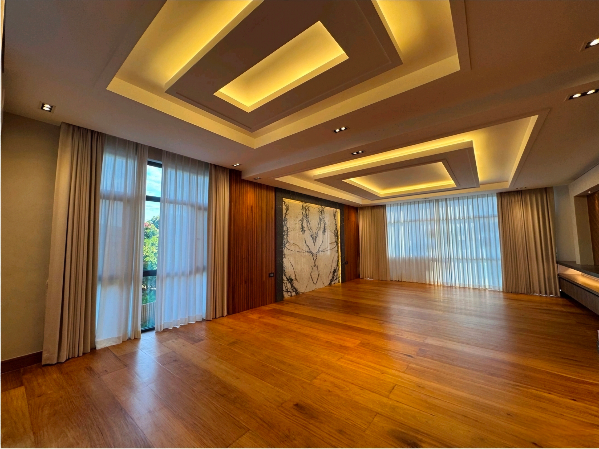 Master bedroom with coffered LED ceiling and Narra plank flooring