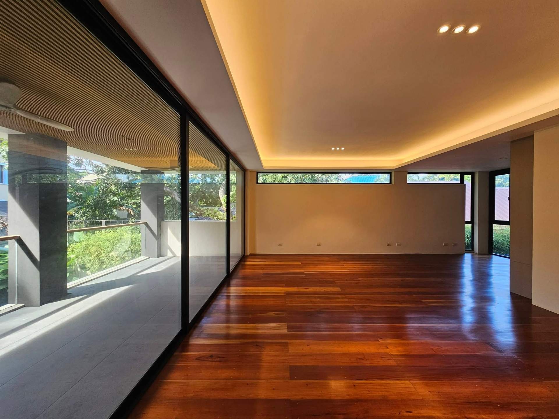 Open second-floor lounge with wood ceiling and floor-to-ceiling glass
