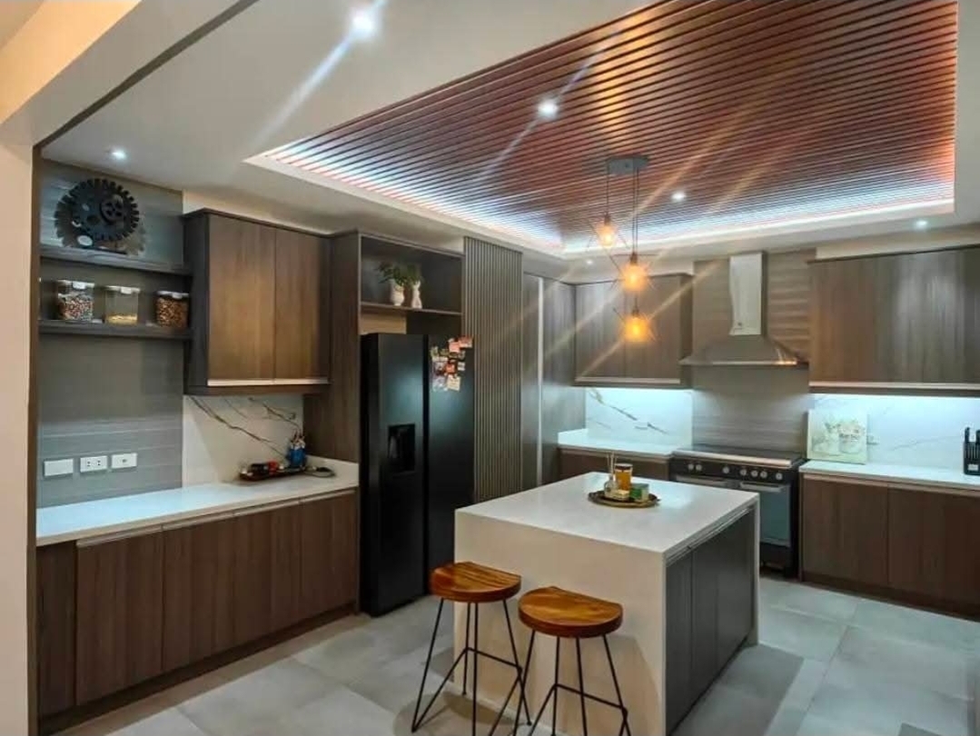 Modern kitchen with island, wood ceiling, and premium appliances