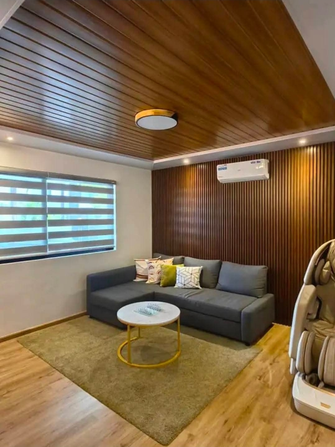 Family lounge with wood feature wall and massage chair