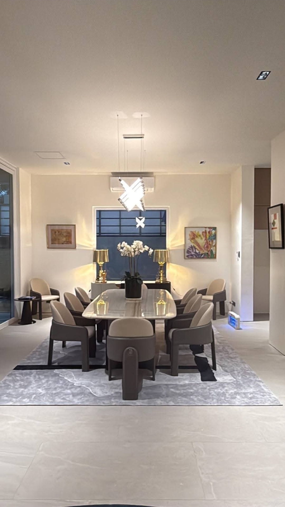 Formal dining room with sculptural pendant lighting