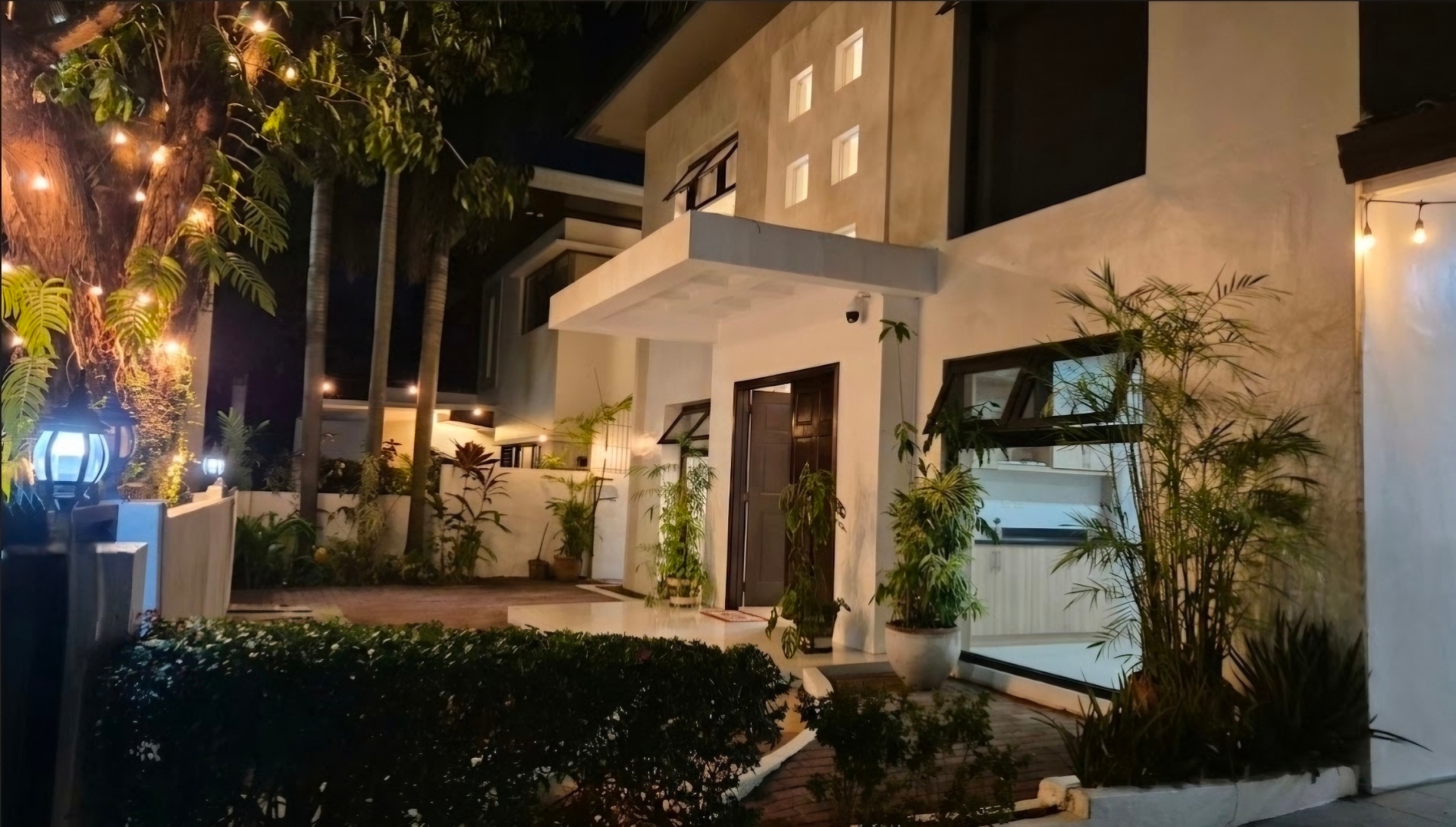 Front entry and landscaped path lit up at night