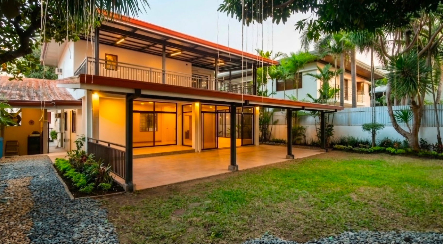 Spacious garden and covered lanai with glass walls