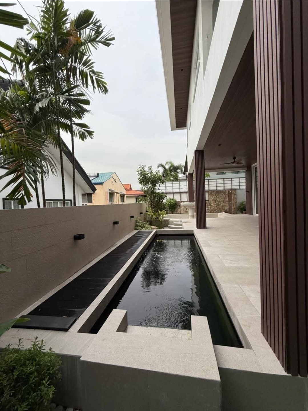 Lap pool and koi pond beside the open lanai