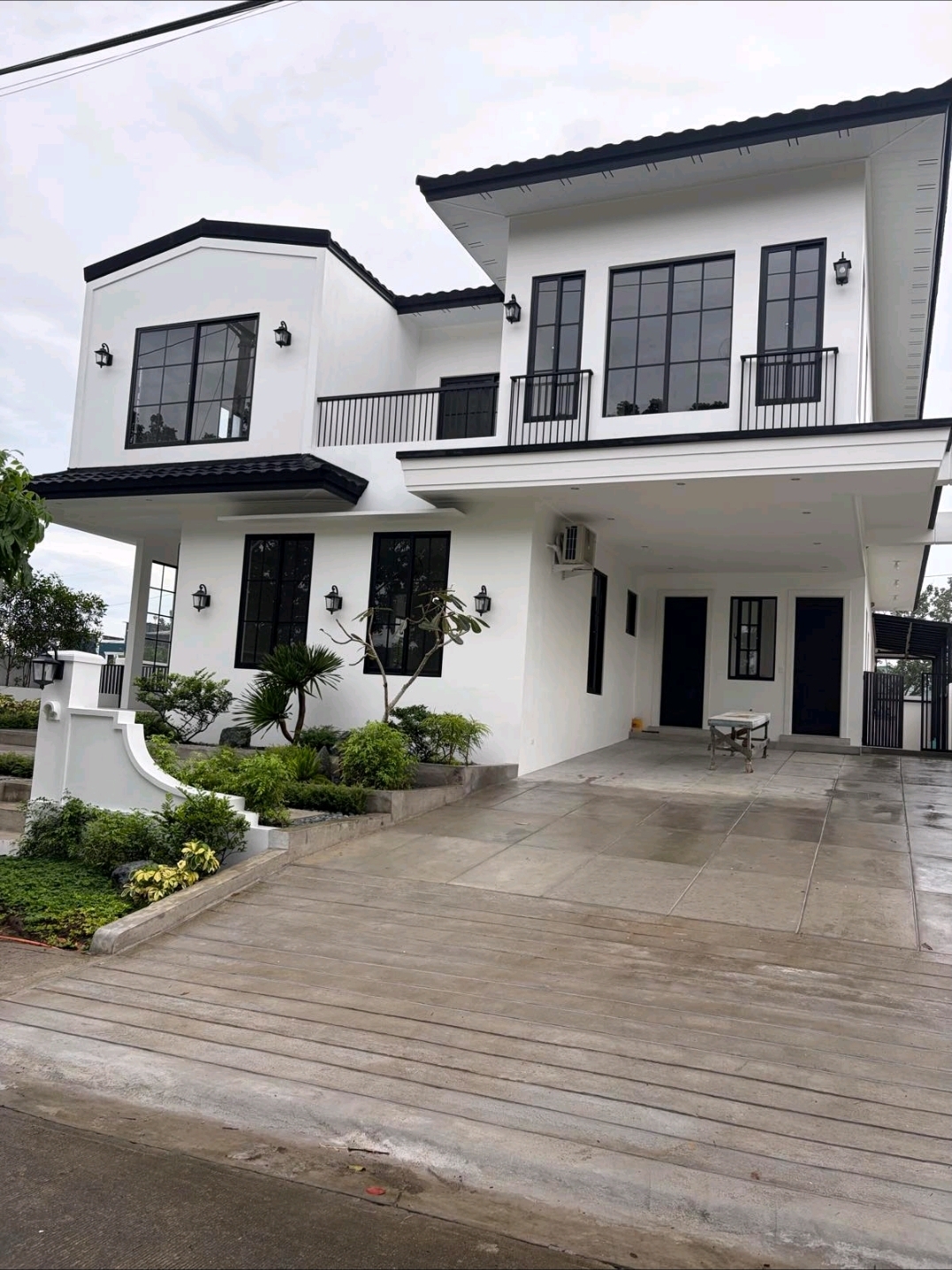 Modern French Contemporary façade with black-framed casement windows and covered carport
