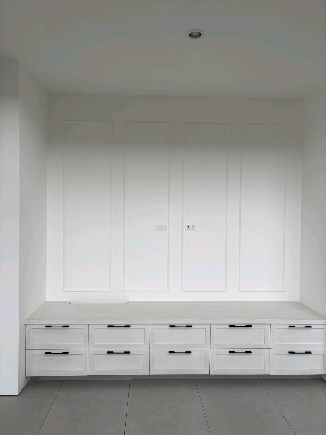 Mudroom bench with wainscoted feature wall and custom drawer storage