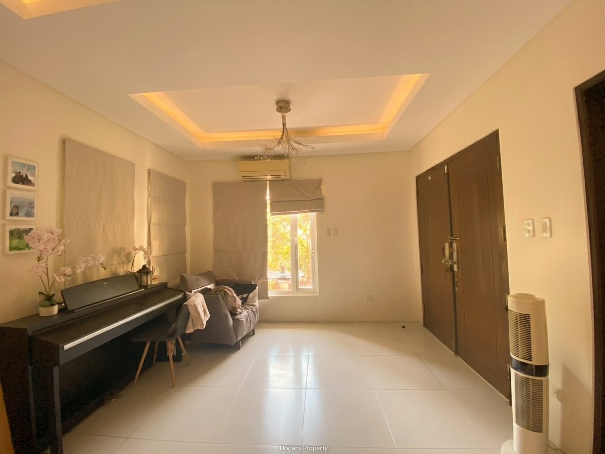 Foyer entry with cove-lit tray ceiling, piano nook and double timber doors