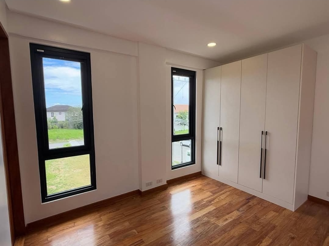 Secondary bedroom with built-in wardrobe and dual aspect windows