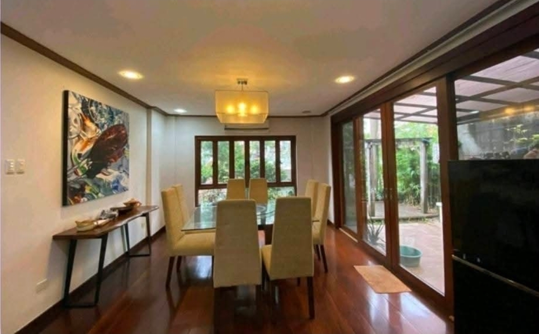 Formal dining area opening to the lanai through full-height glass doors