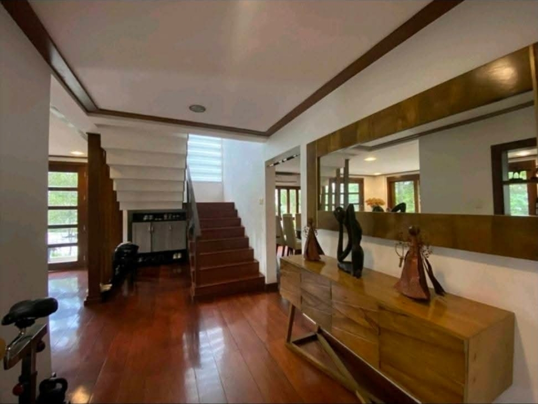 Foyer with sculptural staircase and console mirror