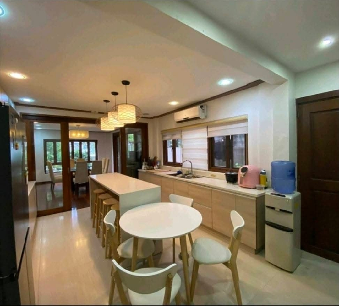 Modern kitchen with island, breakfast nook and pendant lights