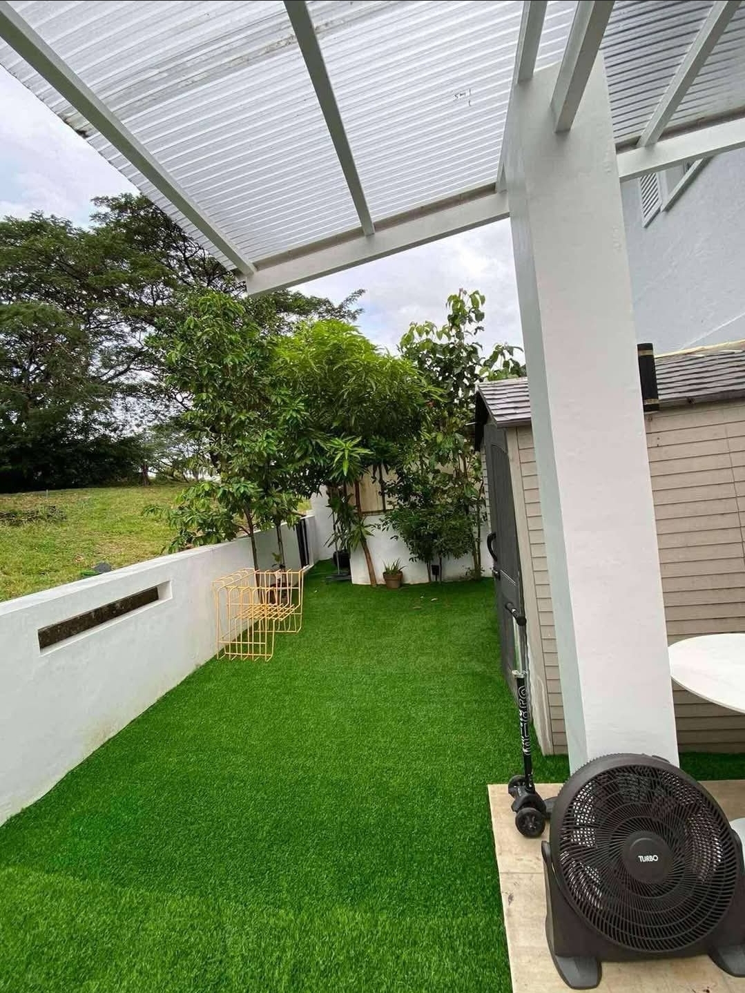 Side garden with manicured lawn and pergola