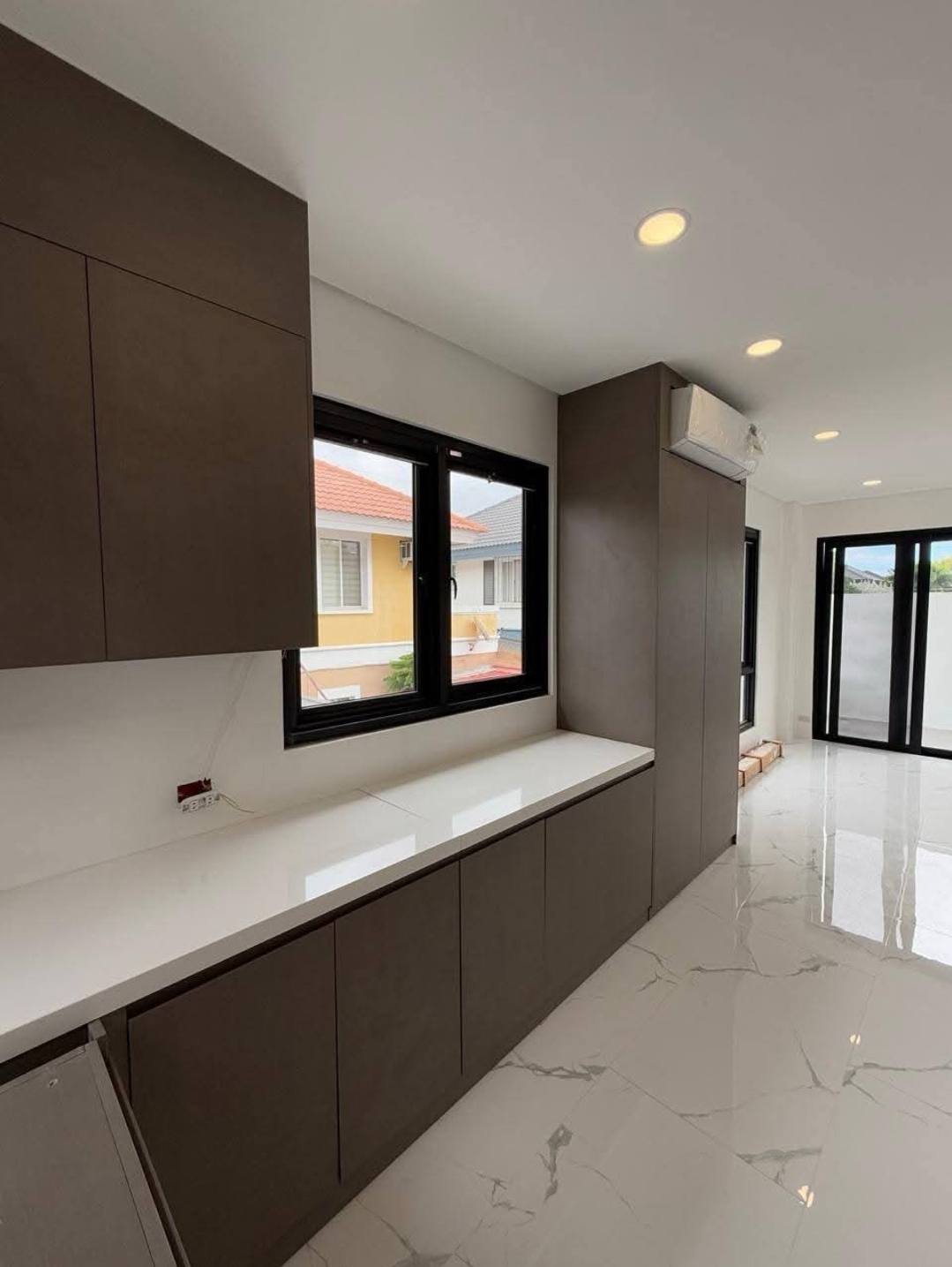 Service pantry with integrated cabinetry and lanai access