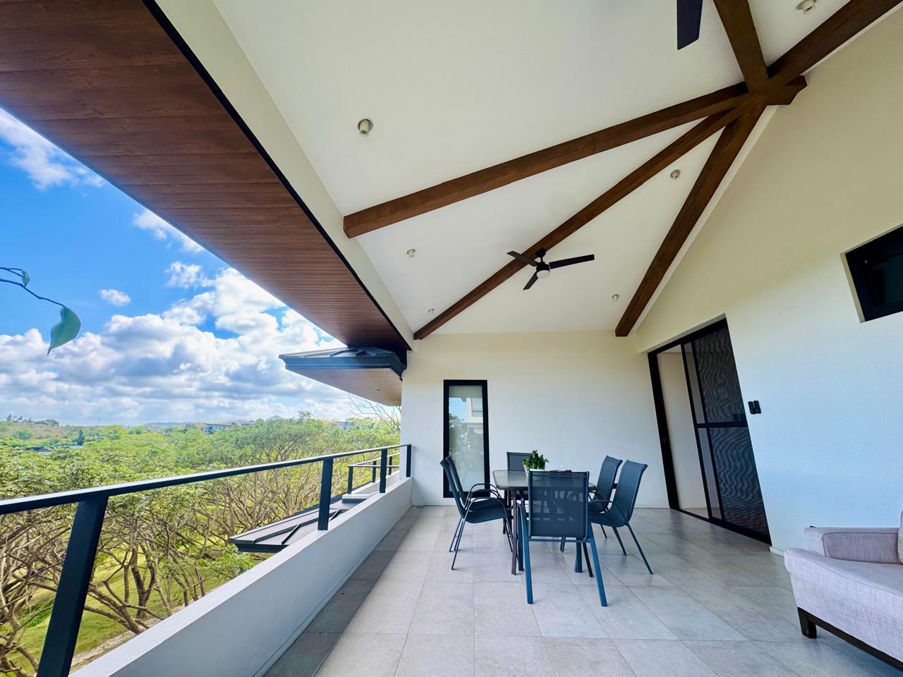 Covered second-floor balcony with vaulted beamed ceiling, ceiling fan and panoramic Silang highland views