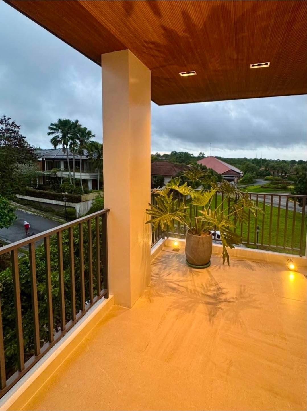 Covered balcony overlooking the village green and tree canopy