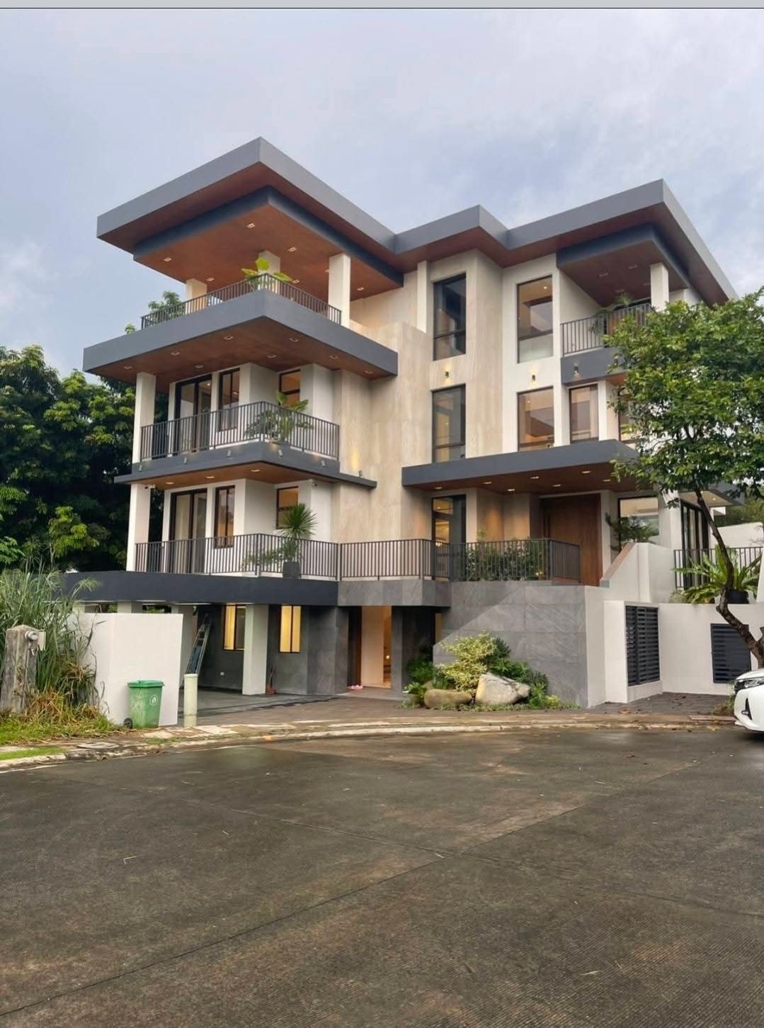 Modern Asian 4-storey façade with cantilevered balconies on a private cul-de-sac