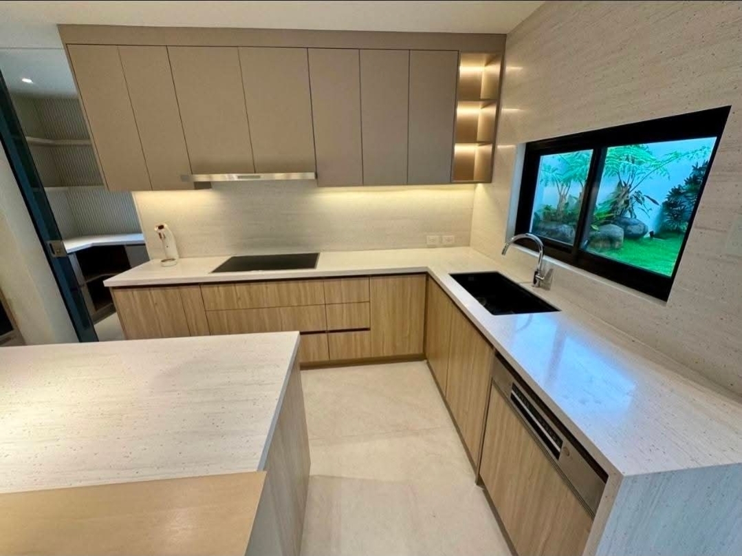 Gourmet kitchen with Bosch appliances, travertine counters, and integrated cabinetry