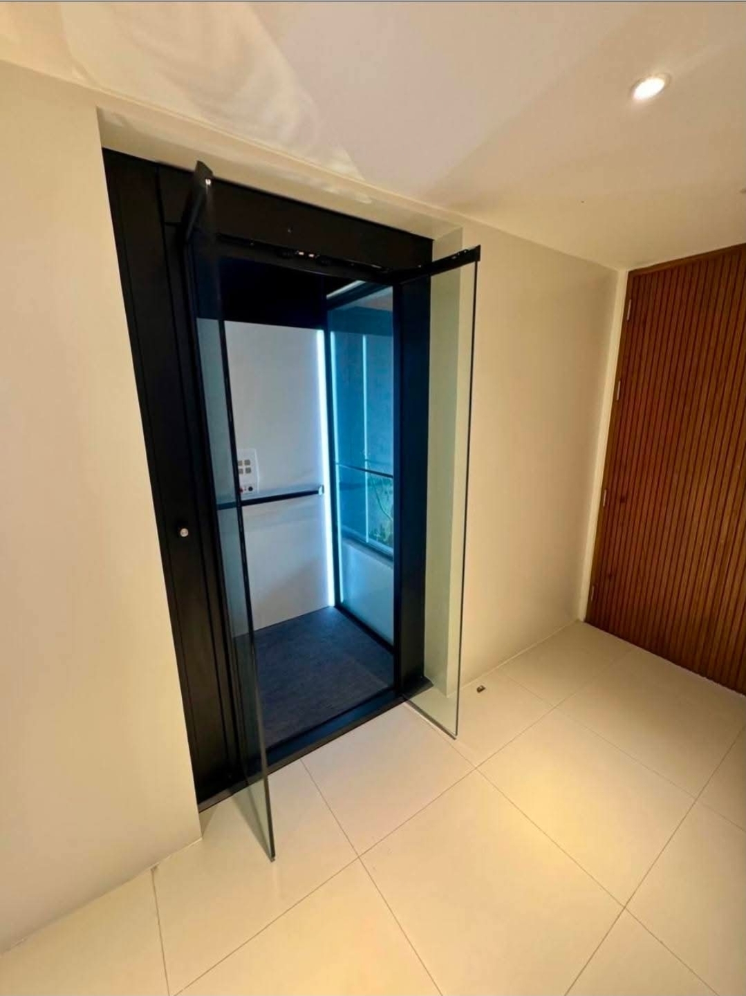 Private Accesso lift with glass enclosure servicing all four storeys