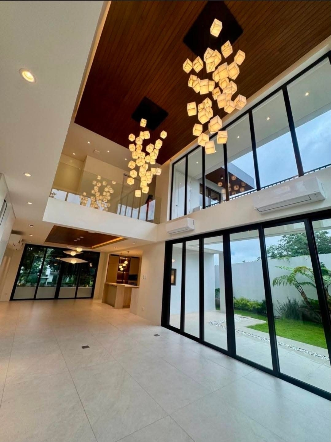 Cathedral living pavilion with cascading cube chandelier